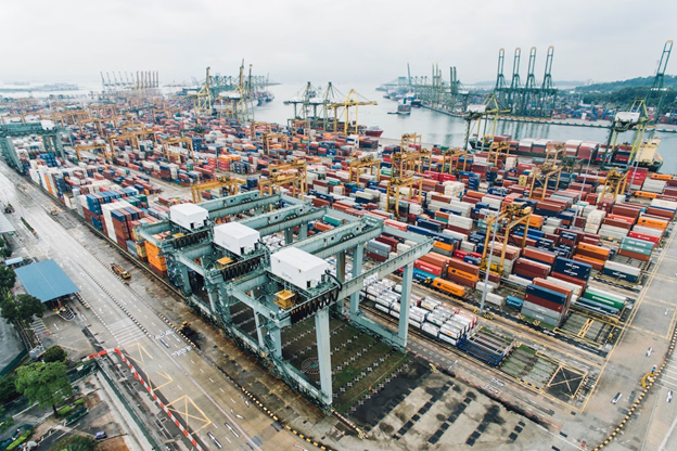 Picture of shipping crates in a port waiting to be loaded on ships.